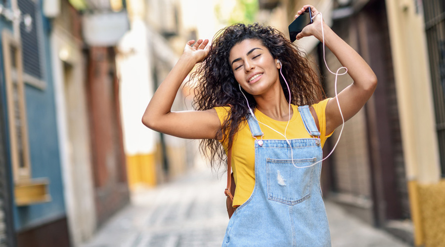 Une jeune femme écoutant de la musique dans la rue